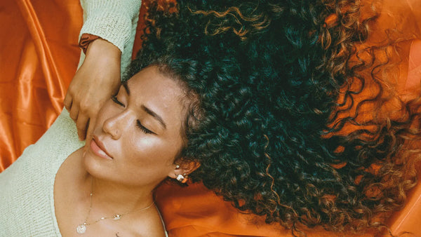 Photo of a woman with curly hair sleeping