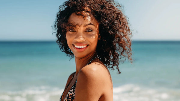 image of a curly hair girl on the beach